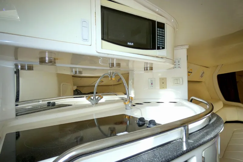  Yacht Photos Pics 2006 Fountain 47 Lightning yacht interior kitchen with microwave and stove.