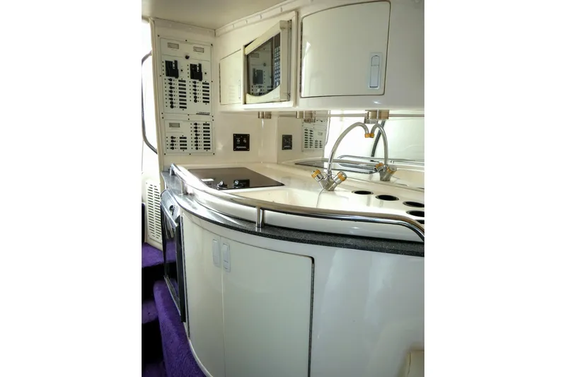  Yacht Photos Pics 2006 Fountain 47 Lightning yacht interior with modern kitchen and control panels.
