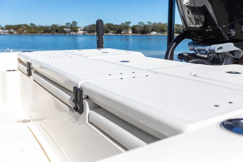  Yacht Photos Pics 2023 ShearWater 260 SS Carolina boat deck with engine, on a sunny day by the water.