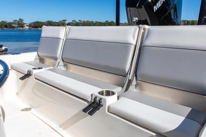  Yacht Photos Pics 2023 ShearWater 260 SS Carolina boat seating with cup holders, docked by a serene lake.
