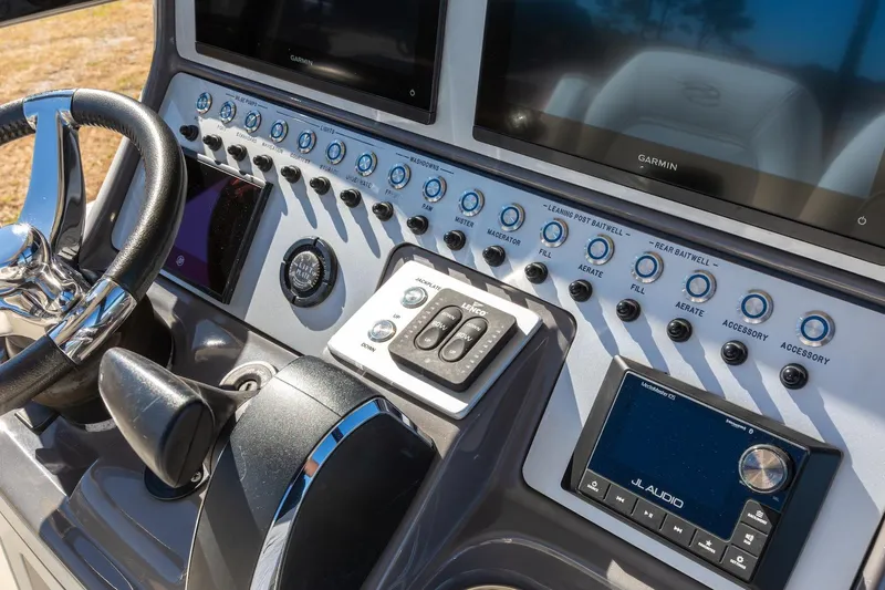  Yacht Photos Pics 2023 ShearWater 260 SS Carolina boat dashboard with steering wheel and control panel.