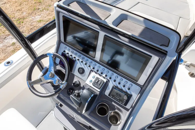  Yacht Photos Pics 2023 ShearWater 260 SS Carolina boat dashboard with dual screens and steering wheel.
