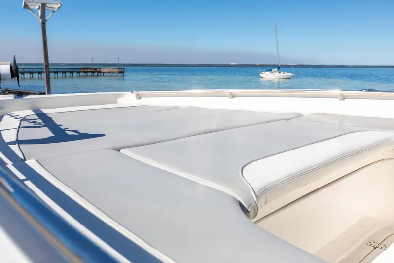  Yacht Photos Pics 2023 ShearWater 260 SS Carolina boat with sun deck, dock, and sailboat in background.