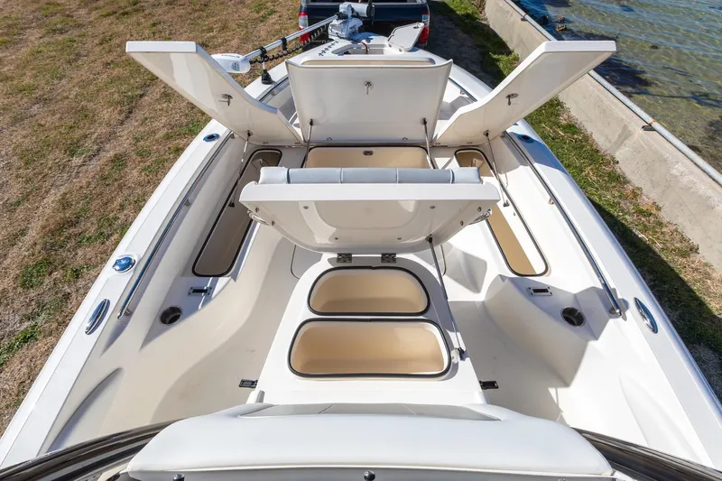  Yacht Photos Pics 2023 ShearWater 260 SS Carolina boat with open storage compartments, docked by the water.