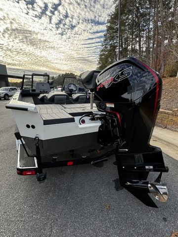 2024 Vexus ADX180 boat with powerful outboard motor, parked on a scenic road.