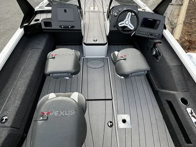 2024 Vexus ADX180 boat interior with gray seating, steering wheel, and control panel.