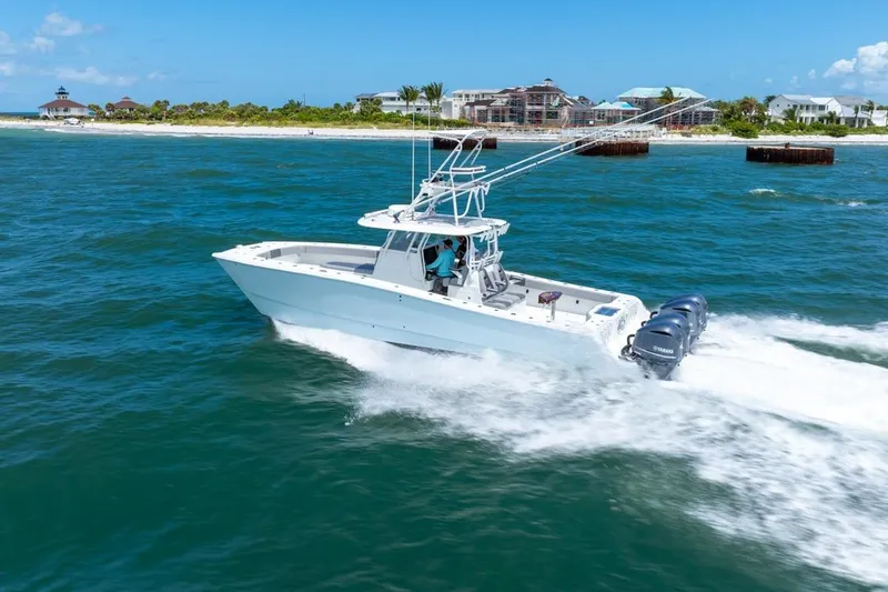  Yacht Photos Pics 2018 Freeman 37VH boat cruising on blue ocean near a scenic coastline.