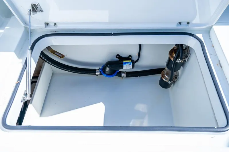  Yacht Photos Pics Open storage compartment in 2018 Freeman 37VH boat, showing hoses and fittings.