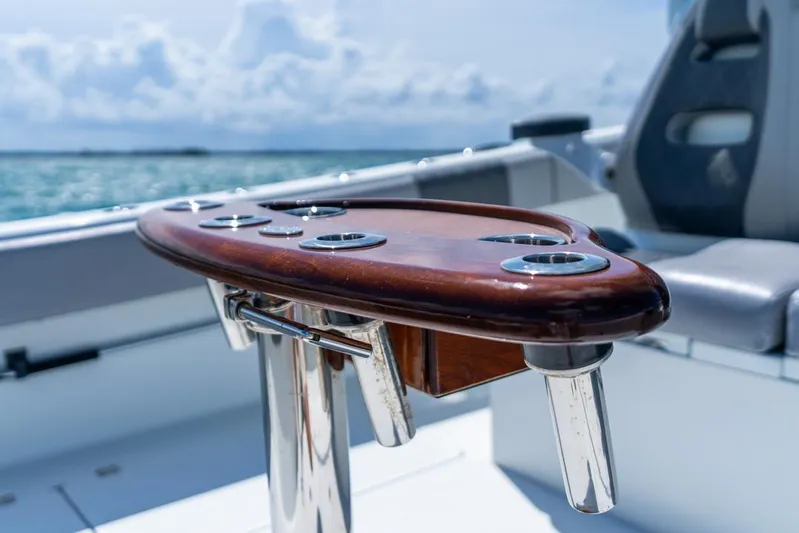  Yacht Photos Pics Freeman 37VH 2018 boat with polished wood rod holder, ocean backdrop.