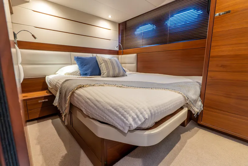 Mamu Yacht Photos Pics Luxurious cabin interior of 2018 Princess F-68 yacht with cozy bed and wooden accents.