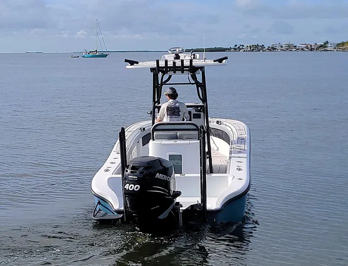  Yacht Photos Pics 2021 Yellowfin 26 Hybrid boat with Mercury 400 engine on calm water.