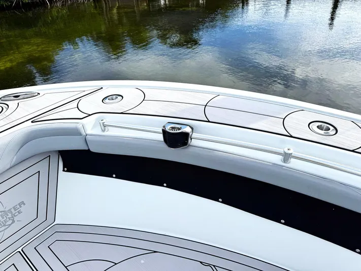  Yacht Photos Pics 2021 Yellowfin 26 Hybrid boat deck with sleek design on calm water.