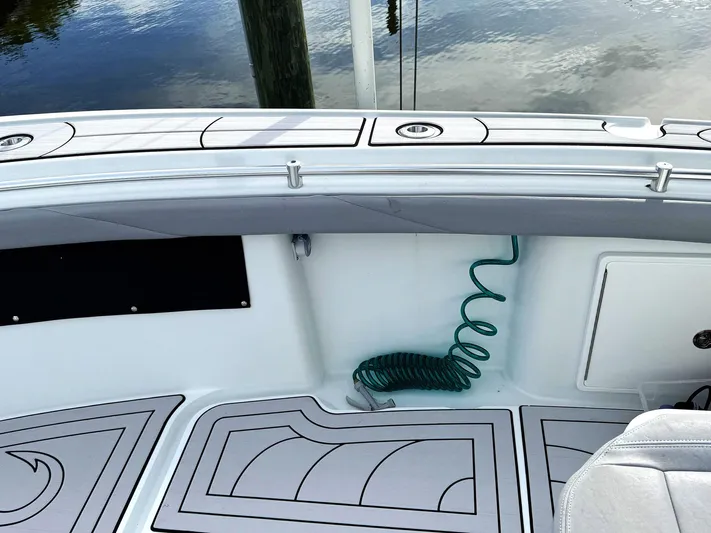  Yacht Photos Pics 2021 Yellowfin 26 Hybrid boat deck with coiled hose and sleek design.