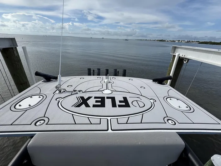  Yacht Photos Pics 2021 Yellowfin 26 Hybrid boat deck with "FLEX" logo, overlooking calm waters.