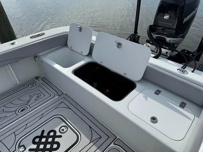  Yacht Photos Pics 2021 Yellowfin 26 Hybrid boat deck with storage compartments and Mercury engine.