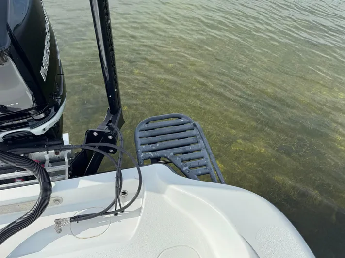  Yacht Photos Pics 2021 Yellowfin 26 Hybrid boat with Mercury engine in shallow water.