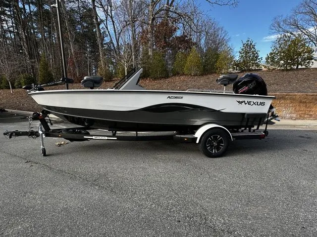 2024 Vexus ADX190 boat on trailer, parked outdoors, showcasing sleek design and modern features.