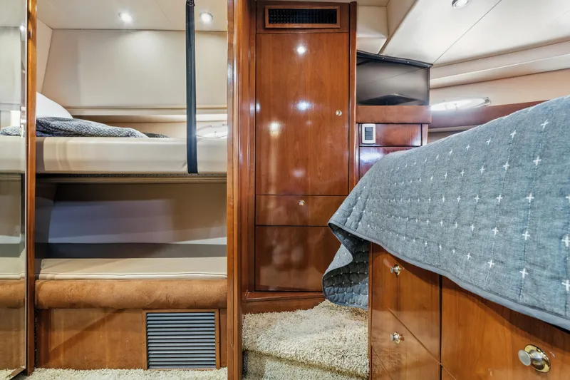 Trust Yacht Photos Pics Luxurious 2007 Meridian 490 Pilothouse cabin interior with wood finishes and cozy bedding.