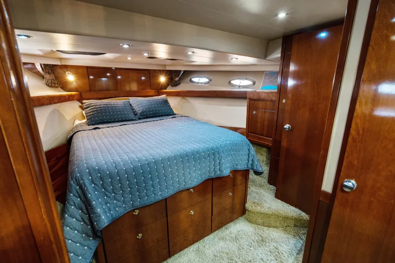 Trust Yacht Photos Pics Luxurious bedroom interior of 2007 Meridian 490 Pilothouse yacht with wood finish.
