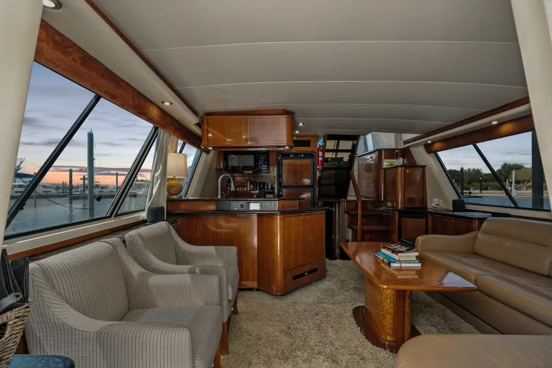 Trust Yacht Photos Pics Luxurious interior of 2007 Meridian 490 Pilothouse yacht with elegant furnishings and panoramic windows.
