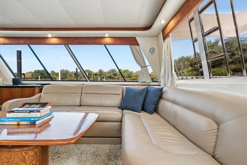 Trust Yacht Photos Pics Luxurious interior of 2007 Meridian 490 Pilothouse yacht with leather seating and scenic windows.