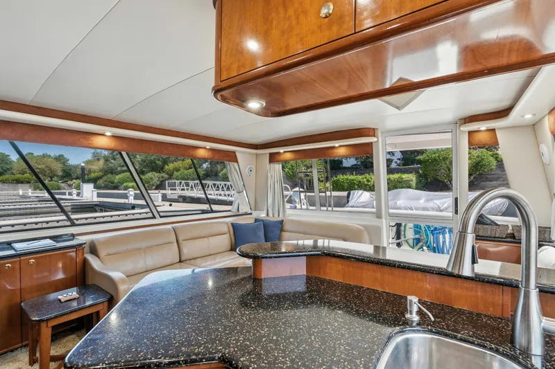 Trust Yacht Photos Pics Luxurious interior of 2007 Meridian 490 Pilothouse yacht with modern kitchen and seating area.