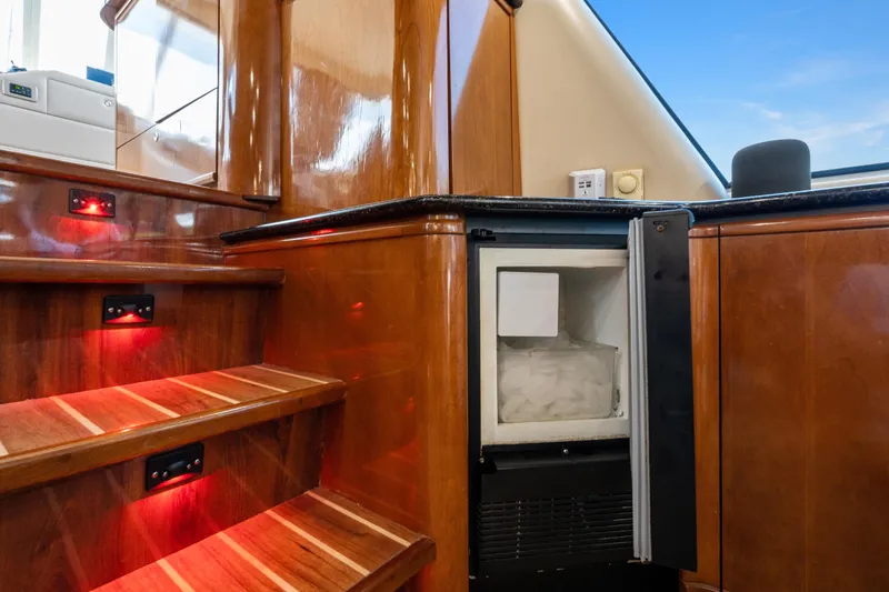 Trust Yacht Photos Pics 2007 Meridian 490 Pilothouse interior with wooden stairs and built-in ice maker.