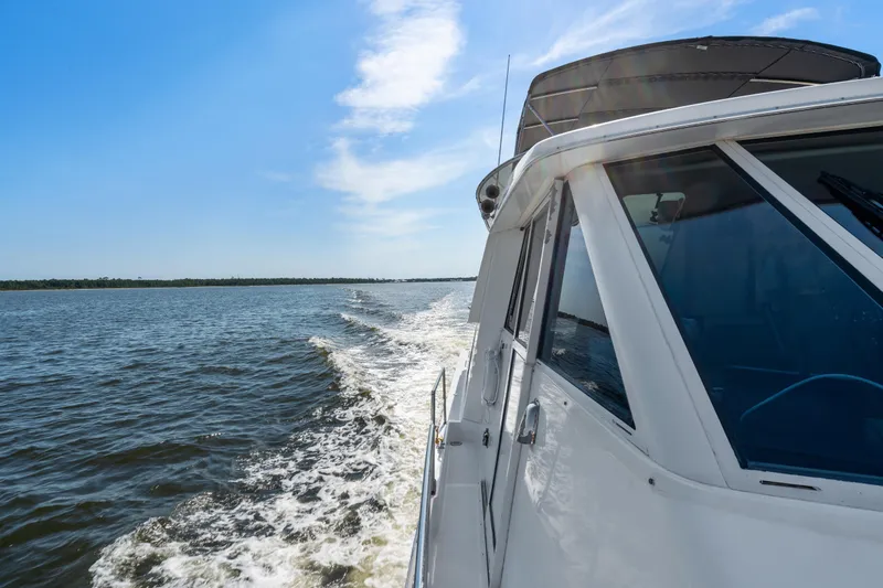 Trust Yacht Photos Pics 2007 Meridian 490 Pilothouse cruising on open water under clear blue sky.