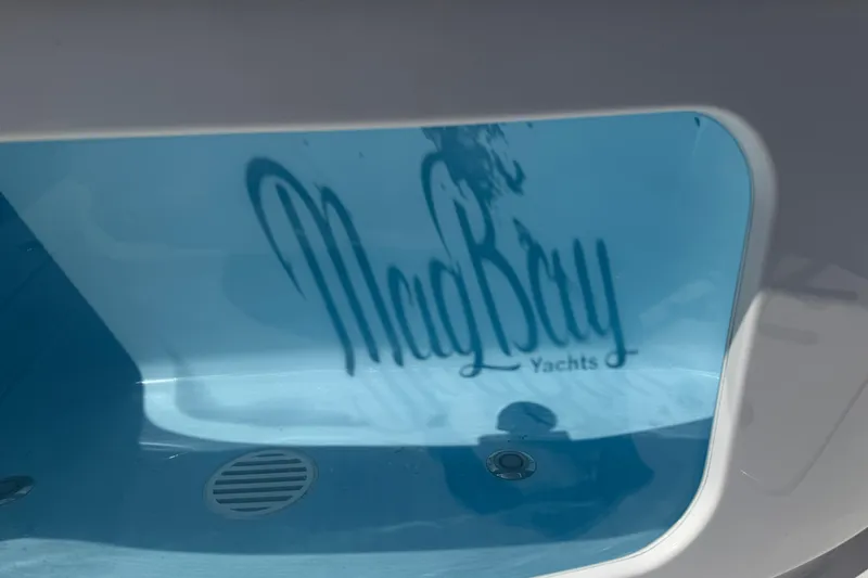  Yacht Photos Pics 2026 Mag Bay 38 CC yacht interior with logo reflection in water.