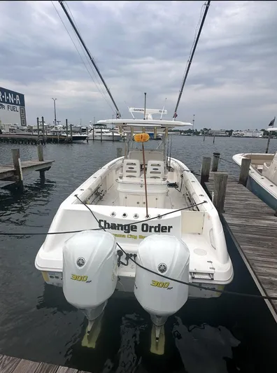  Yacht Photos Pics 2004 Boston Whaler 320 Outrage docked with twin engines, overcast sky.