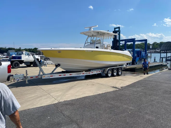  Yacht Photos Pics 2004 Boston Whaler 320 Outrage on trailer at marina, sunny day.
