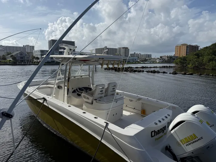  Yacht Photos Pics 2004 Boston Whaler 320 Outrage boat docked near waterfront buildings under cloudy sky.