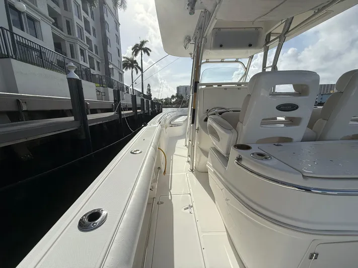  Yacht Photos Pics 2004 Boston Whaler 320 Outrage boat docked, featuring sleek white interior and seating.