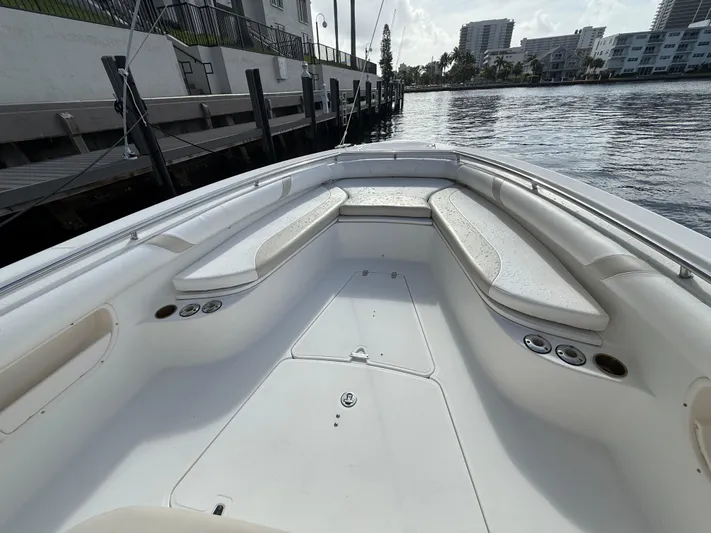  Yacht Photos Pics 2004 Boston Whaler 320 Outrage boat interior with white seating and waterfront view.