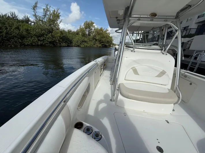 Yacht Photos Pics 2004 Boston Whaler 320 Outrage boat interior, featuring seating and waterway view.