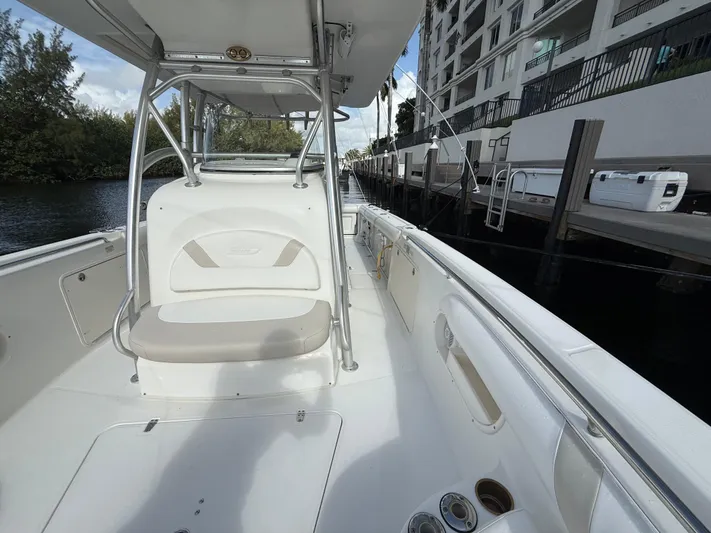  Yacht Photos Pics 2004 Boston Whaler 320 Outrage boat docked near waterfront building.