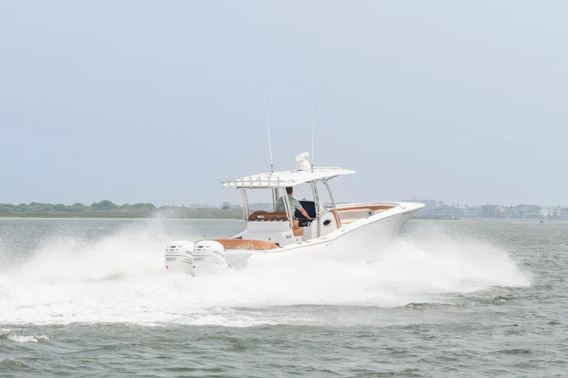  Yacht Photos Pics 2022 Mag Bay 33cc boat cruising on water with twin engines.