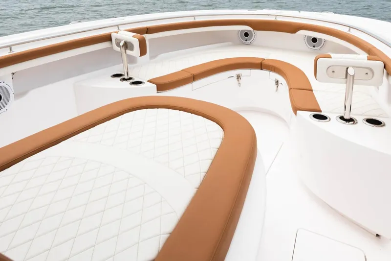  Yacht Photos Pics 2022 Mag Bay 33cc boat interior with tan and white cushioned seating.