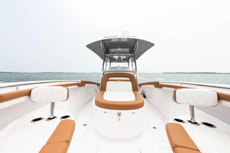  Yacht Photos Pics 2022 Mag Bay 33cc boat interior with tan and white seating.