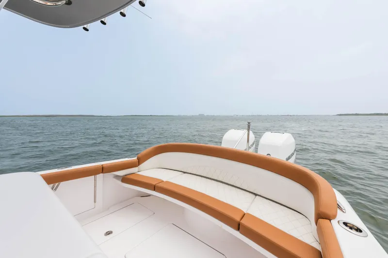  Yacht Photos Pics 2022 Mag Bay 33cc boat with cushioned seating and twin engines on open water.