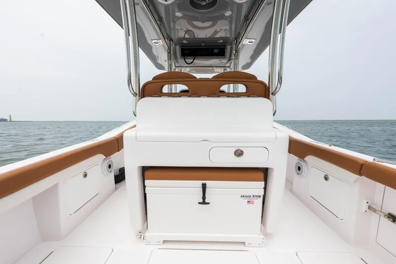  Yacht Photos Pics 2022 Mag Bay 33cc boat interior with seating and storage, ocean in the background.