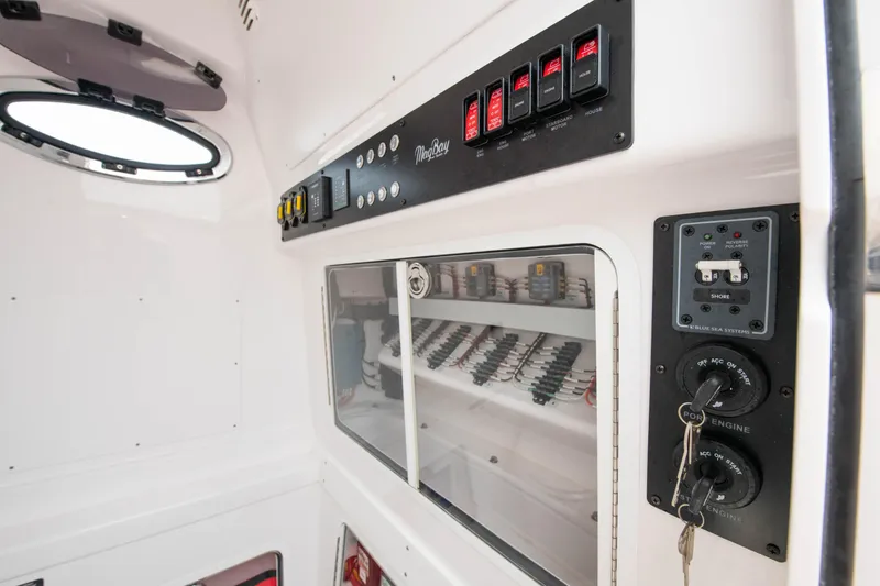  Yacht Photos Pics Control panel and storage area inside a 2022 Mag Bay 33cc boat.