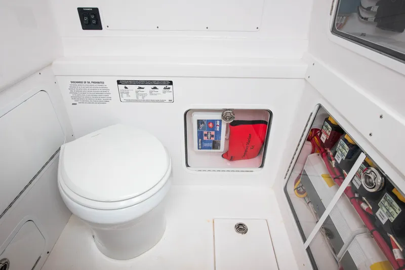  Yacht Photos Pics 2022 Mag Bay 33cc boat interior with toilet and storage compartments.