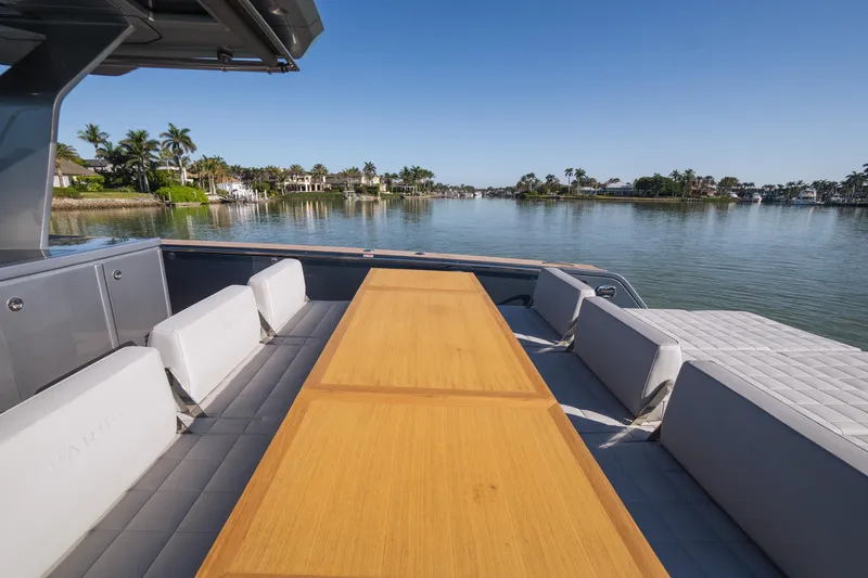  Yacht Photos Pics 2025 Pardo Yachts P43 deck with seating and table, overlooking serene waterfront view.