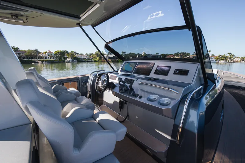  Yacht Photos Pics 2025 Pardo Yachts P43 helm with modern controls and luxurious seating on a serene waterway.