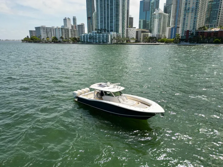 Yacht Photos Pics 2021 Scout 380 LXF boat on water with city skyline background.