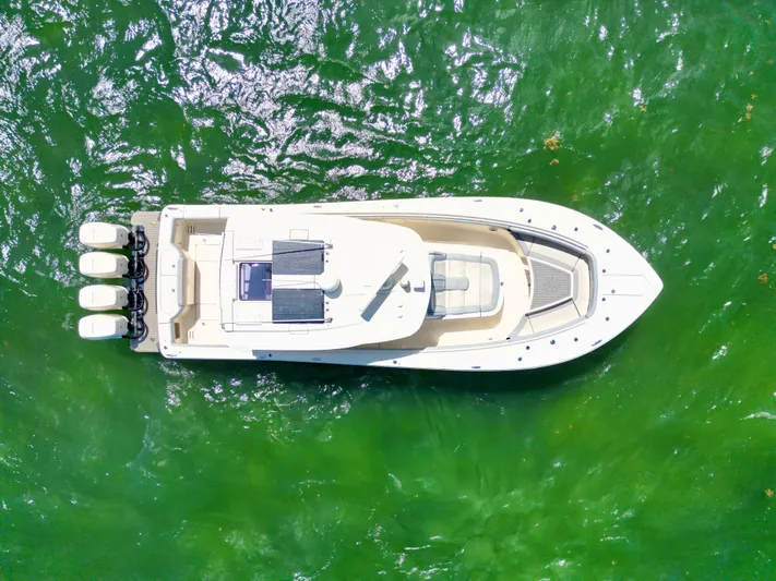 Yacht Photos Pics Aerial view of 2021 Scout 380 LXF boat on vibrant green water.
