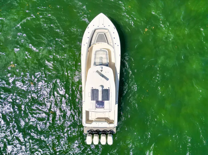  Yacht Photos Pics Aerial view of 2021 Scout 380 LXF boat on vibrant green water.
