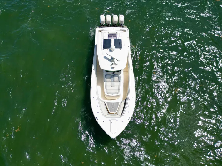  Yacht Photos Pics Aerial view of 2021 Scout 380 LXF boat on green water.