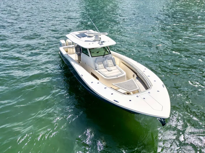  Yacht Photos Pics 2021 Scout 380 LXF boat on water, showcasing sleek design and luxury features.